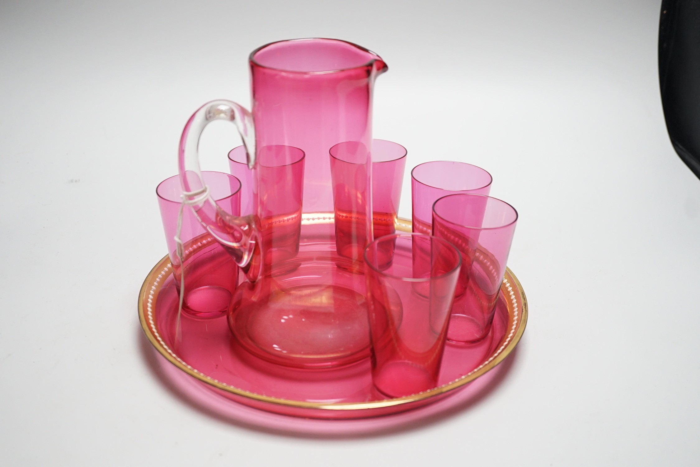 A cranberry glass lemonade six glass set, jug and tray